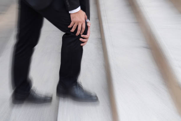 istock business man with knee pain, obstacle concept 1296762077