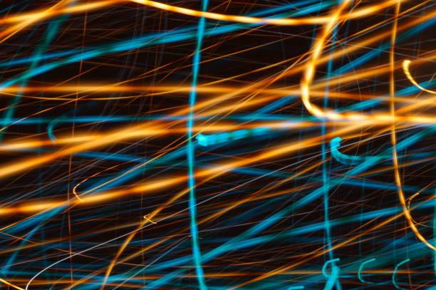 istock Water threads on black background - abstract graphic background showing azure irregular lines and chaotic ribbons. 1296763127
