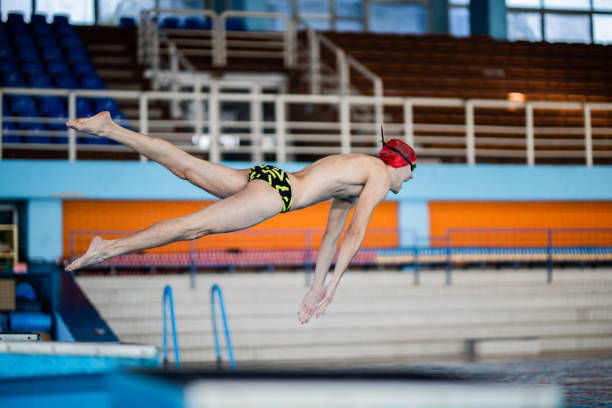 istock Swimmer is jumping into water 1296767164