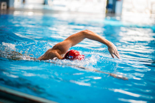 Male has swimming training in the pool stock photo