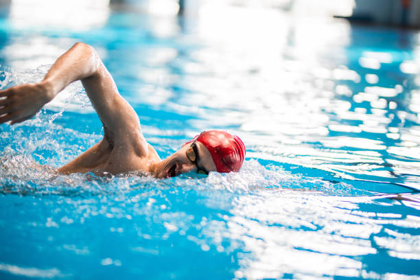 istock Young men freestyle swimming 1296767180