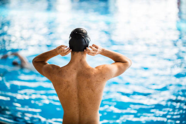 istock Tightning swimming cap before swimming competition 1296767212
