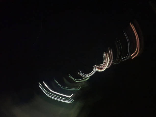 istock An abstract pattern of curved lines made by lights in the night sky. 1296775824