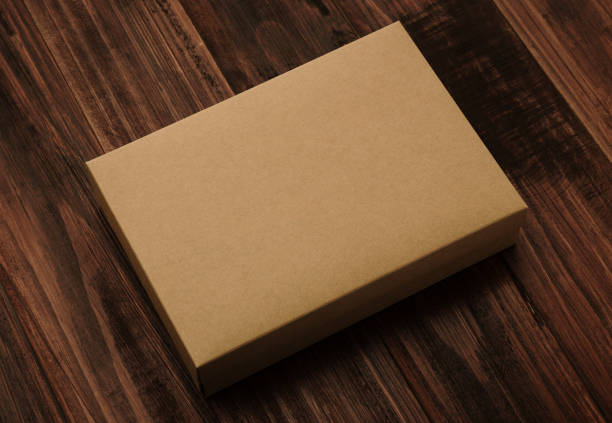 istock Blank cardboard brown box, Kraft paper box mockup on wooden background 1296775982
