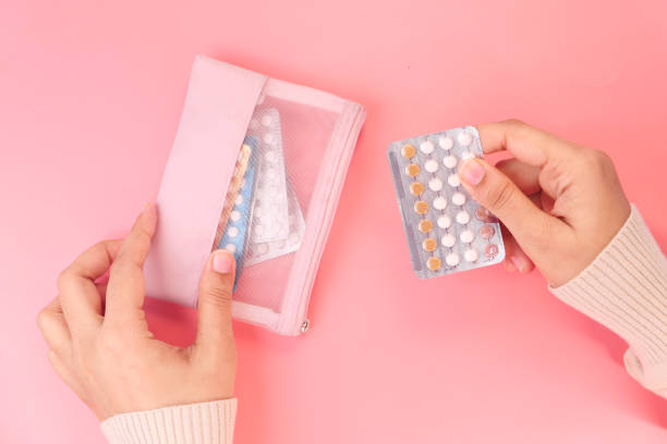istock women hand golding birth control pills close up 1296779721