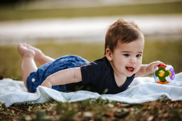istock Happy baby boy laying outside on blanket 1296780526