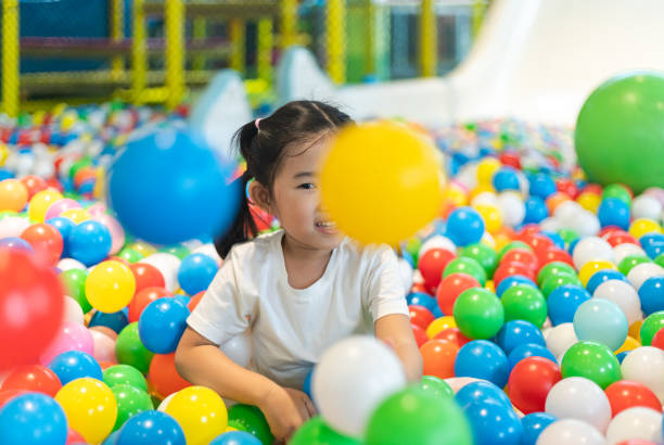 istock Cute girl at the Ball Pool 1296781190