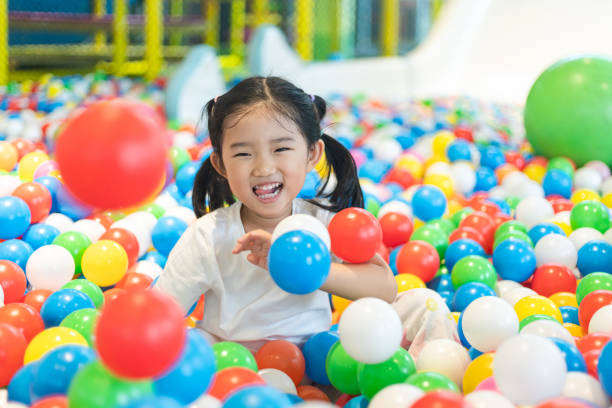istock Cute girl at the Ball Pool 1296781757