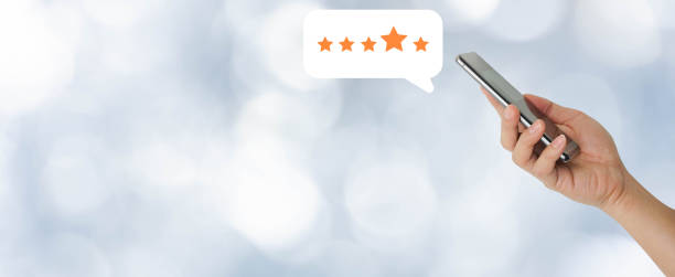 istock close up on customer man hand pressing on smartphone screen with  five star rating feedback icon and press level good rank for giving best score point to review the service , technology business concept 1296782537