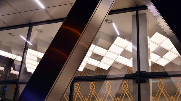 istock Pattern of office buildings windows illuminated at night. 1296794190