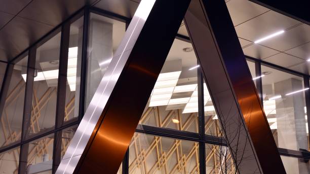 istock Pattern of office buildings windows illuminated at night. 1296794404