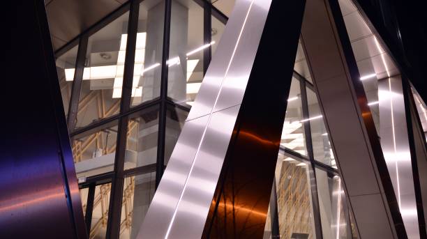istock Pattern of office buildings windows illuminated at night. 1296794431