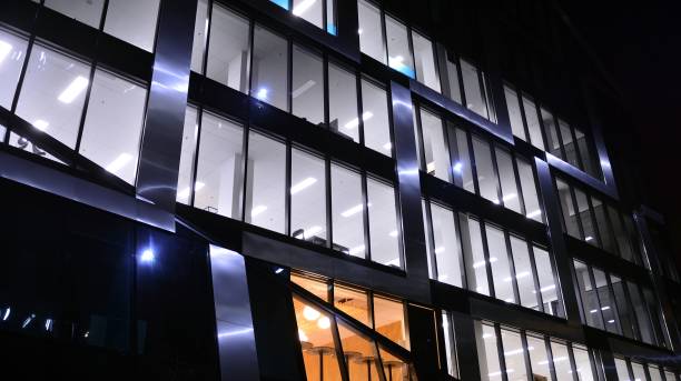 istock Pattern of office buildings windows illuminated at night. 1296794470