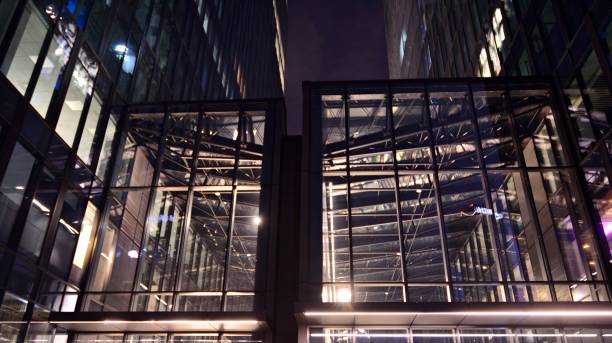 istock Pattern of office buildings windows illuminated at night. 1296795169