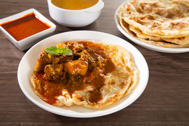 istock Roti Parata or Roti canai with lamb curry sauce - popular Malaysian breakfast 1296798657