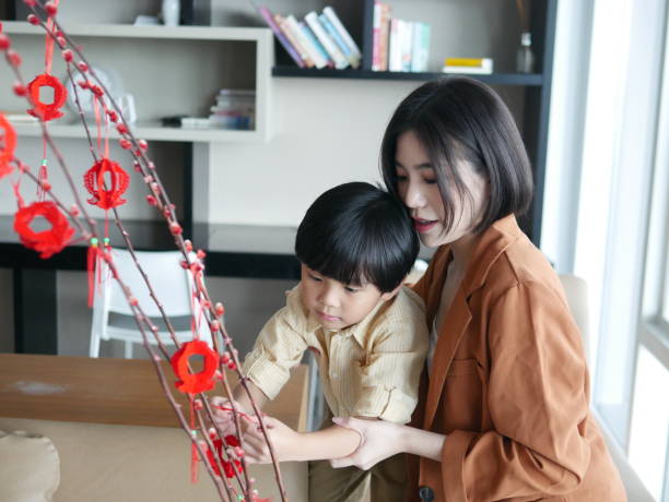 istock Mother and son decorating home for Chinese New Year 1296803482