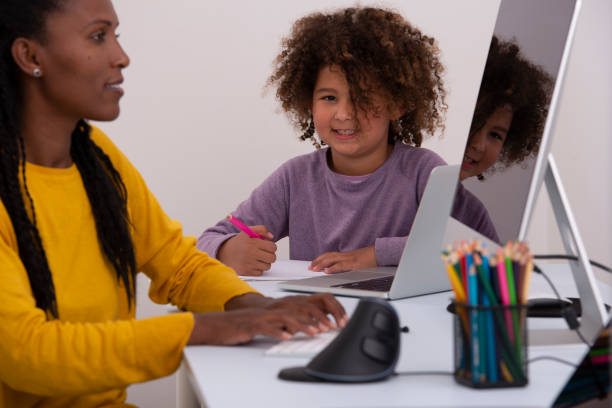 istock Mother and daughter working and study online. 1296806580