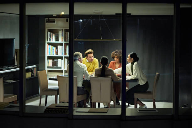 istock Diverse Corporate Team Working Late in Modern Office 1296811917