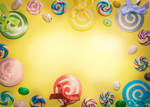 birthday background, bright yellow background with candies lollipops, sweets