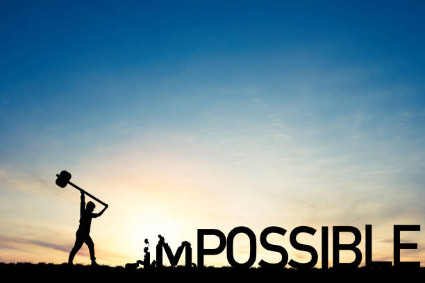 Mindset concept ,Silhouette  man smashed with a hammer to destroy impossible to possible  wording on blue sky and sunlight.