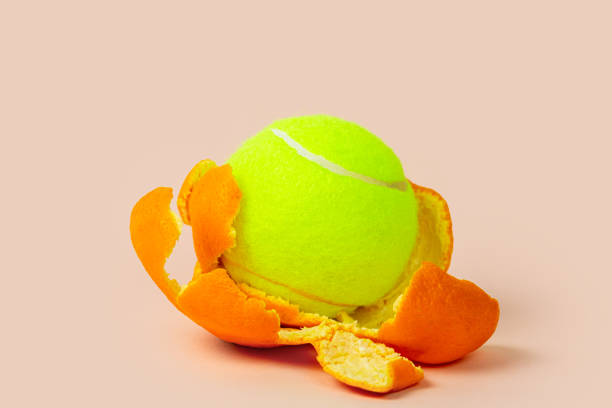 istock Tennis ball covered in orange peel 1296821630
