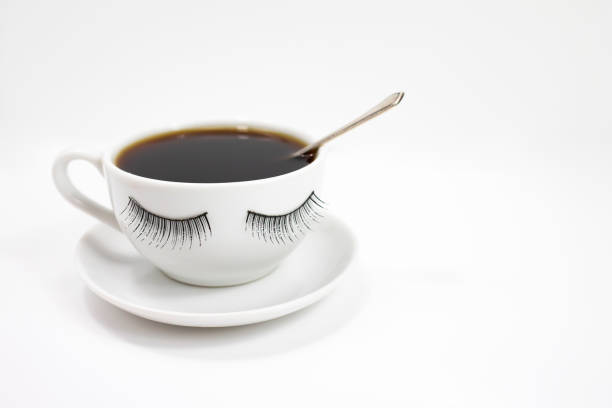 istock A funny white coffee cup with eyelashes on a white background. Side view. 1296822261