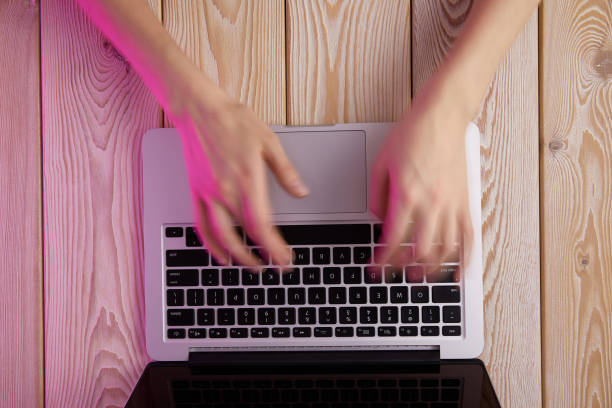 istock Image of woman's hands typing fast on laptop keyboard. View from above. Remote work concept image. 1296822847