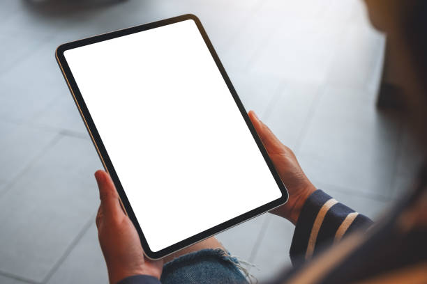 istock a woman holding digital tablet with blank white desktop screen 1296823484