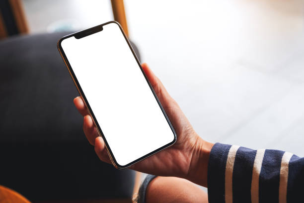 istock a woman holding mobile phone with blank white desktop screen 1296823521
