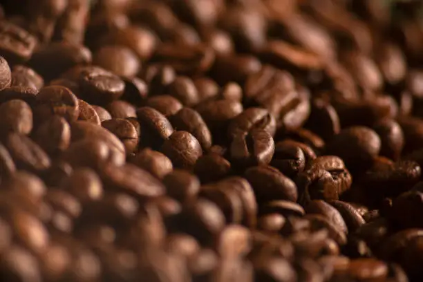 Close up Roasted coffee beans with copy space. macro. Fresh coffee grains wallpaper. Good morning. Coffee shop.