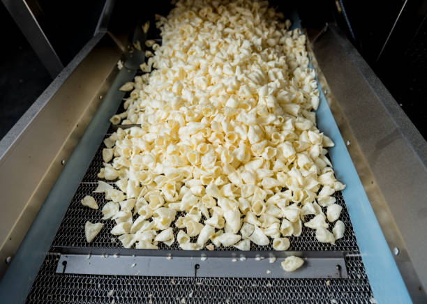 istock Conveyor line for frying snacks and chips in a modern factory 1296823915