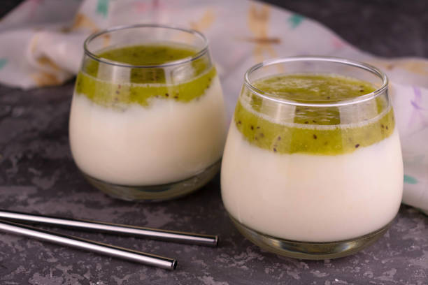 istock Two glasses with healthy kiwi and yogurt smoothies. Close-up. 1296824765