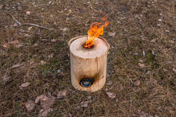 istock Vertical fire of Finnish (Swedish) log candle at river coast 1296825912