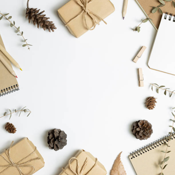 Gift boxes, note book, dry plant on white background. flat lay, top view, copy space