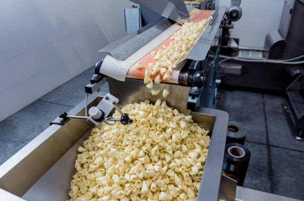 istock Conveyor line for packing snacks and chips in a modern factory 1296826289