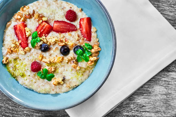 Oatmeal with strawberries and blueberries for breakfast. Healthy food and diet. Delicious and healthy food for weight loss stock photo