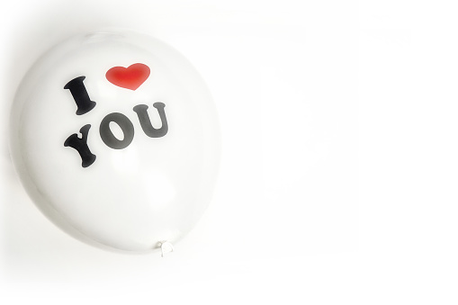 I love you written on a white balloon with red heart on white background. Valentines Day, Birthday or romantic concept Copy space love space for text