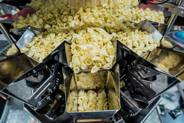 istock Vertical multi-head weigher packaging machine snacks and chips in a factory 1296827685