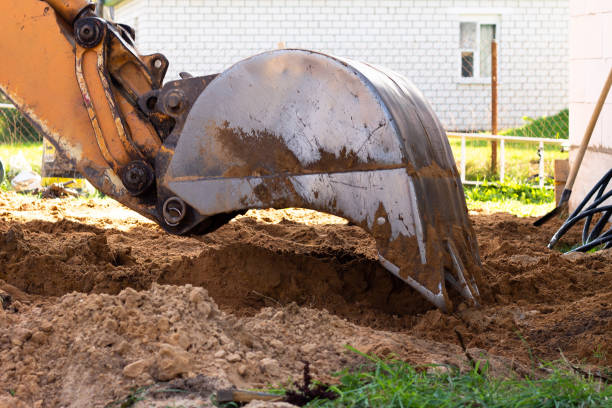 istock An excavator metal bucket digs sand or clay on a construction site while digging a trench. 1296828318