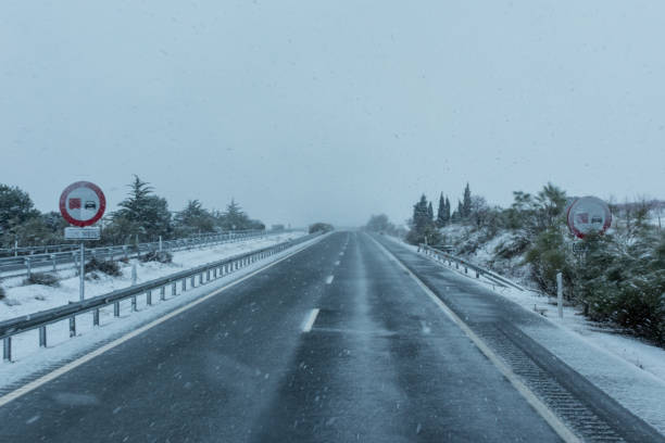 istock Vertical traffic signs forbidden to overtake trucks with snow 1296828557