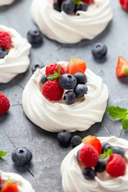 Meringue nest mini pavlova cake with fresh berries strawberry blueberry raspberry and mint for healthy desert