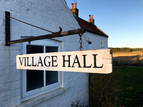 A village hall sign at a public meeting place ￼in a small village with the local community