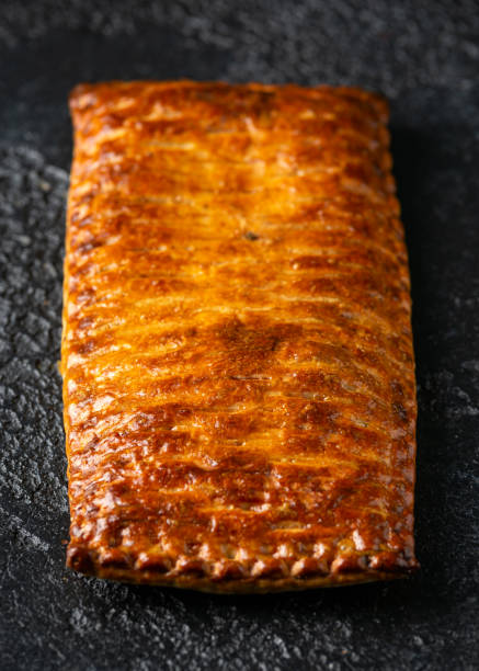 istock Steak and onion lattice pie on rustic black background 1296830841