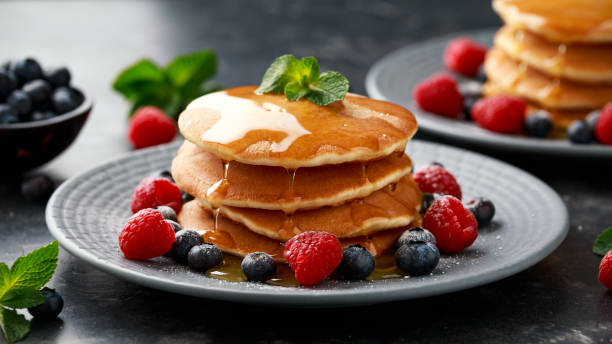 istock American pancakes with fresh blueberry, raspberry and honey. Healthy morning breakfast 1296830997