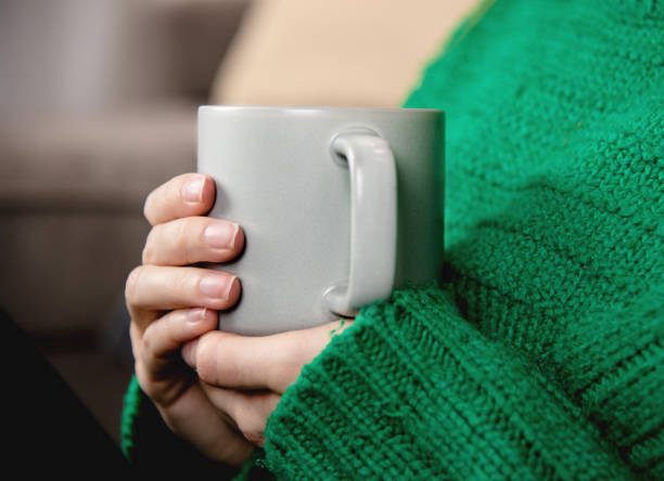 istock Woman holding cup with hot drink close up. 1296832931