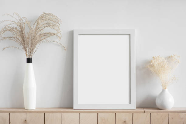istock Blank picture frame mockup on white wall. Living room design 1296833072