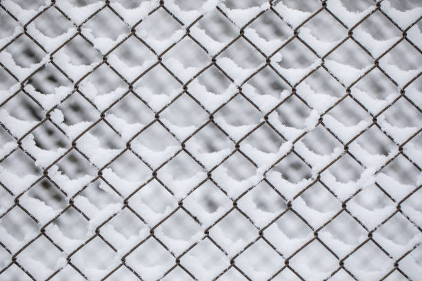 istock Snow on Abstract Chainlink Fence stock photo 1296833469