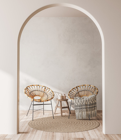 El interior se maqueta con sillones de ratán de madera, alfombras de moda y elegantes accesorios para el hogar sobre fondo de pared beige. photo