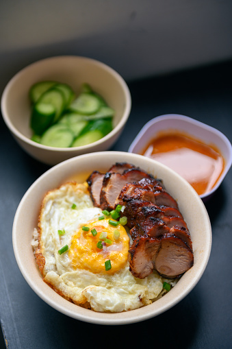 Rice bowl topped with Barbecue pork belly and fried egg