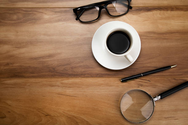 istock magnifier with glasses and coffee 1296834380